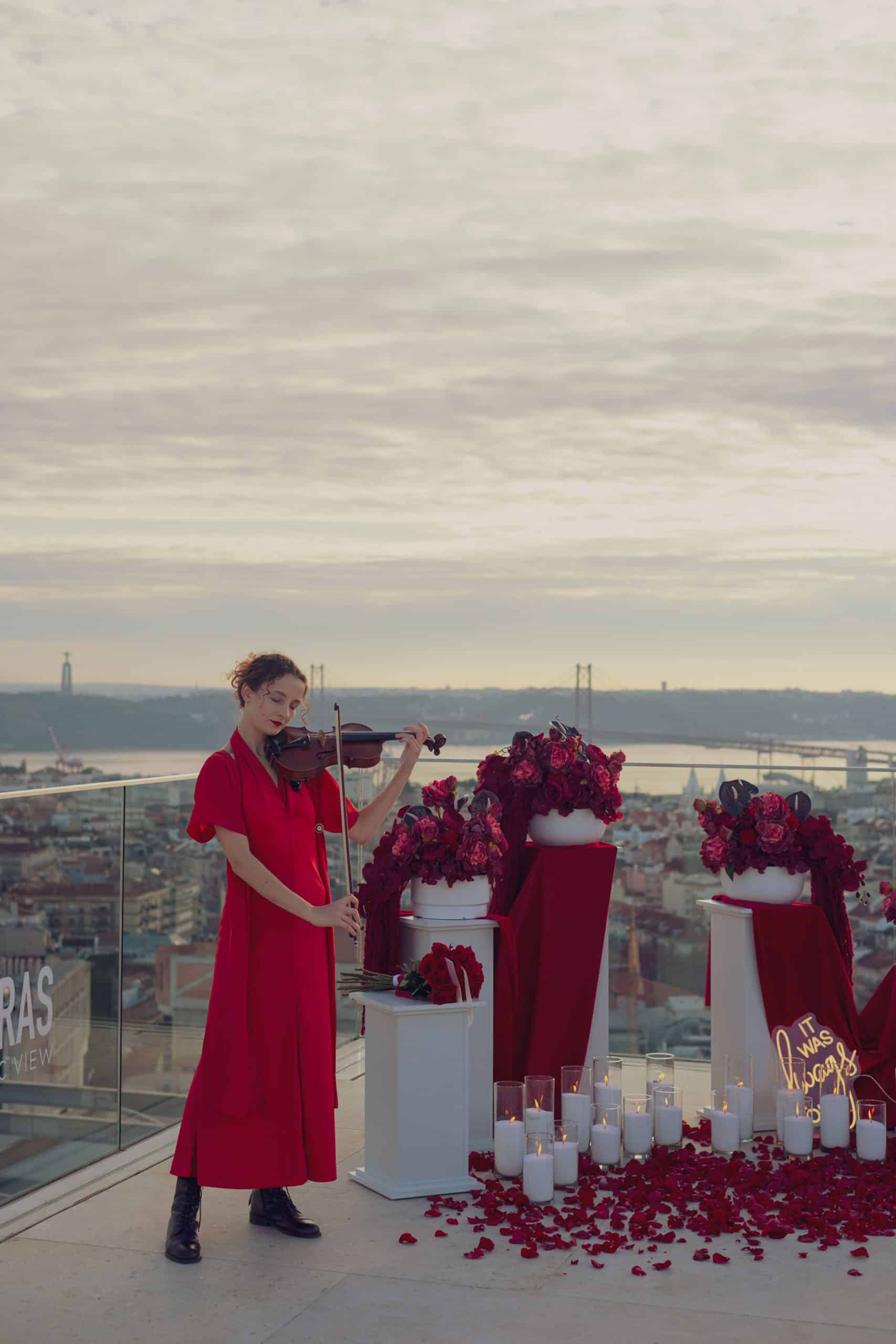 Romantic rooftop proposal in Lisbon with violin music at sunset